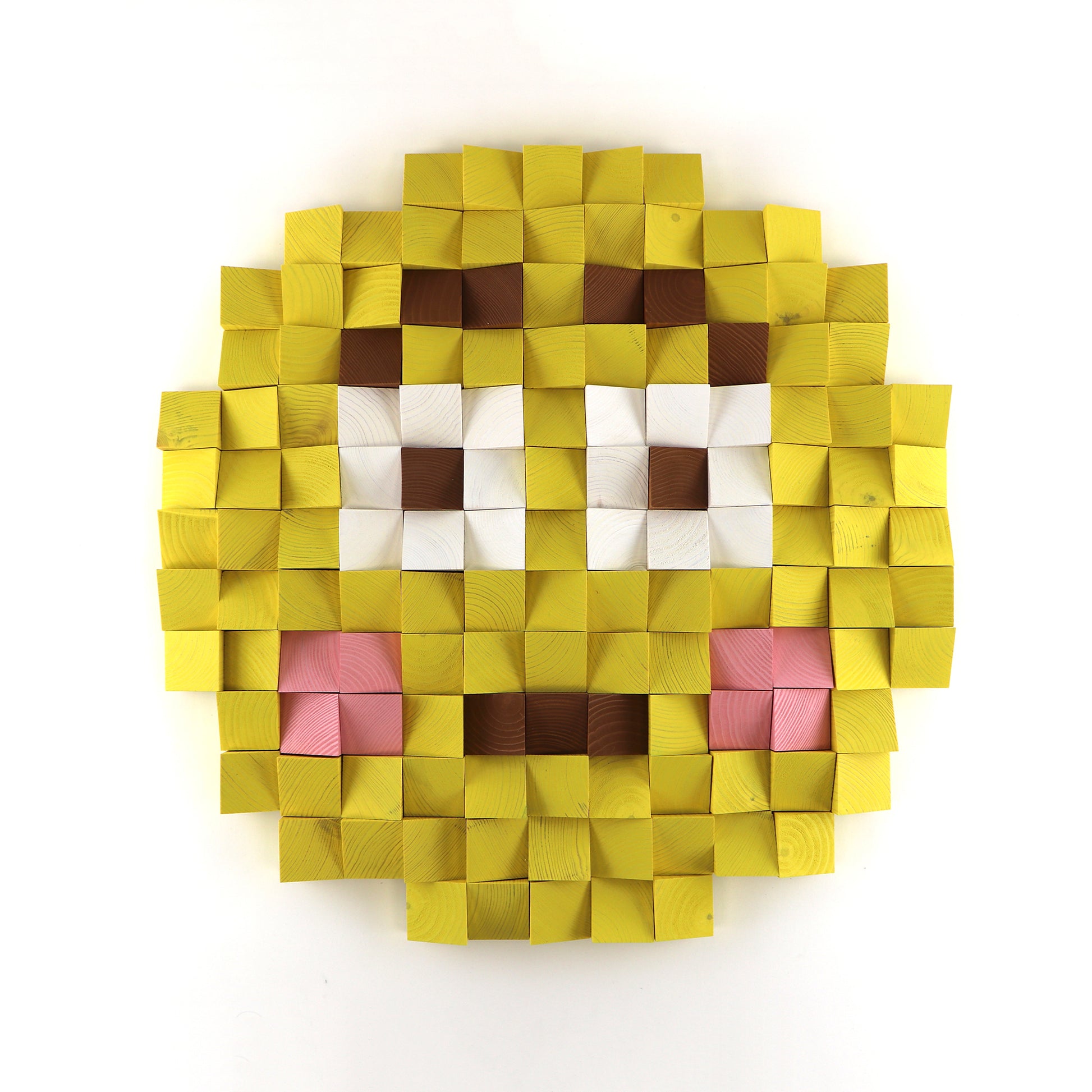 Flushed face emoji 3D wooden wall art with pink cheeks, handcrafted from layered yellow wood blocks in a pixel-style design.
