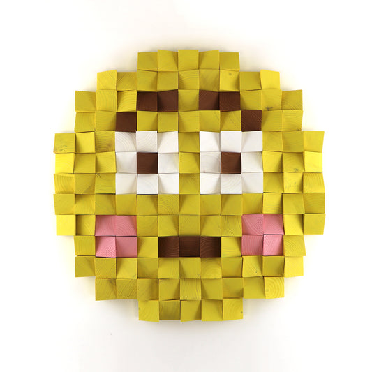 Flushed face emoji 3D wooden wall art with pink cheeks, handcrafted from layered yellow wood blocks in a pixel-style design.