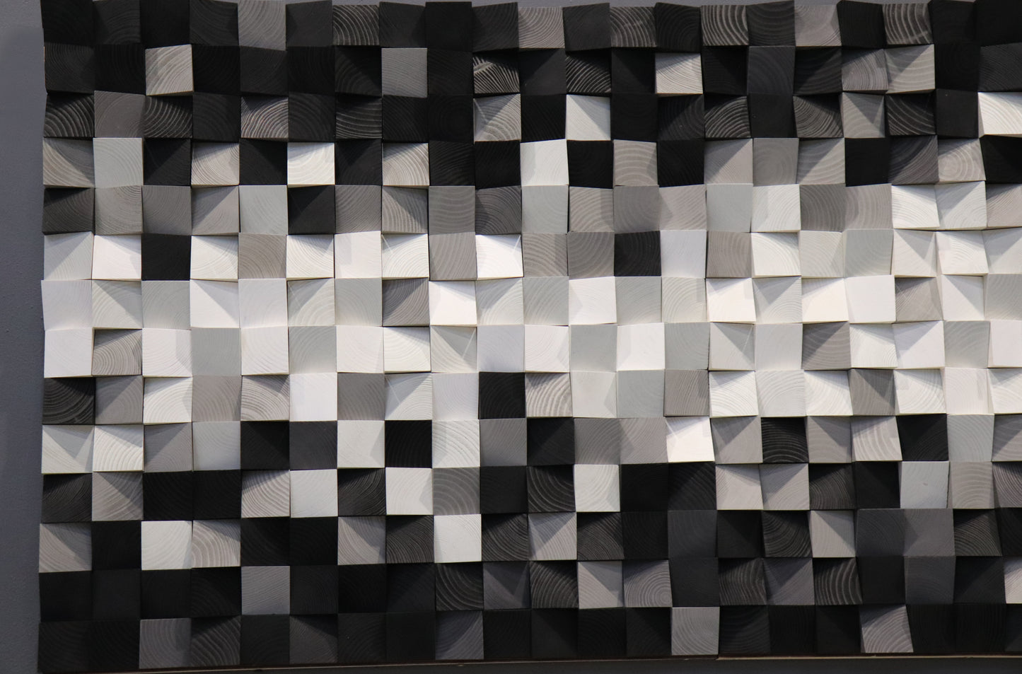 Three-dimensional wooden wall panel in monochrome tones, handcrafted for stylish interior design.