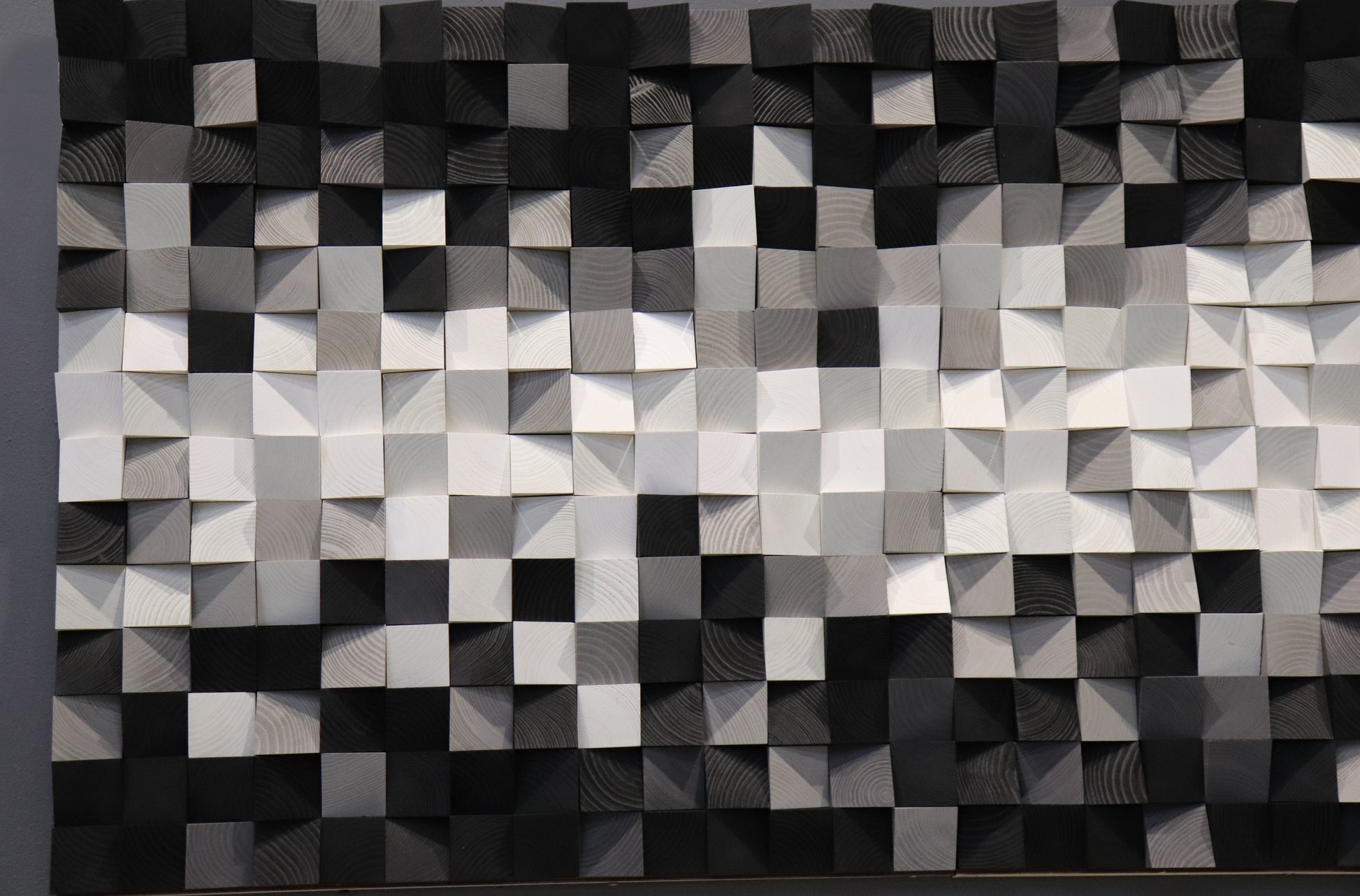 Three-dimensional wooden wall panel in monochrome tones, handcrafted for stylish interior design.