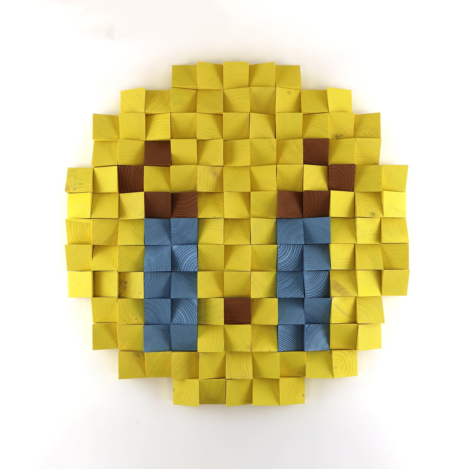 Loudly crying face emoji 3D wooden wall art with blue tears, handcrafted from layered yellow wood blocks in a pixel design.