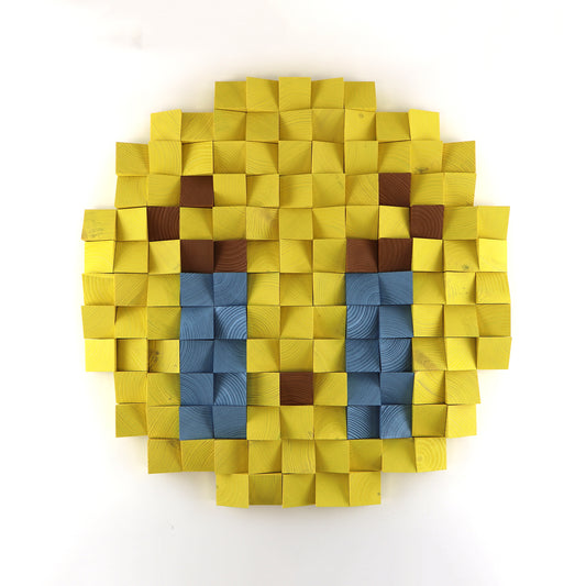 Loudly crying face emoji 3D wooden wall art with blue tears, handcrafted from layered yellow wood blocks in a pixel design.
