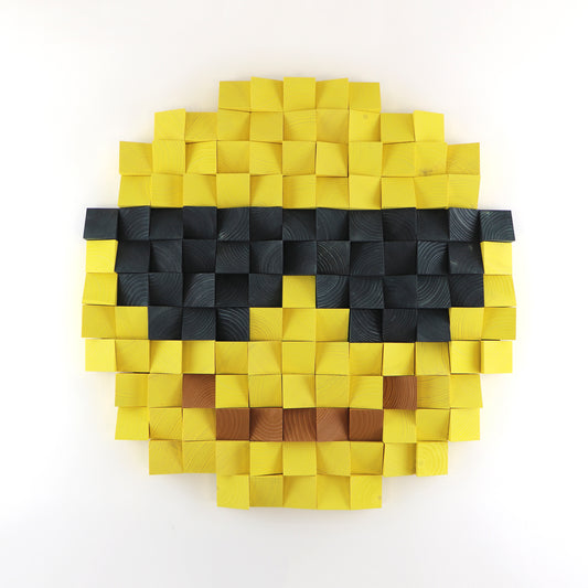 Smiling face with sunglasses emoji wall art made from layered yellow and black wooden blocks in a 3D pixel style.
