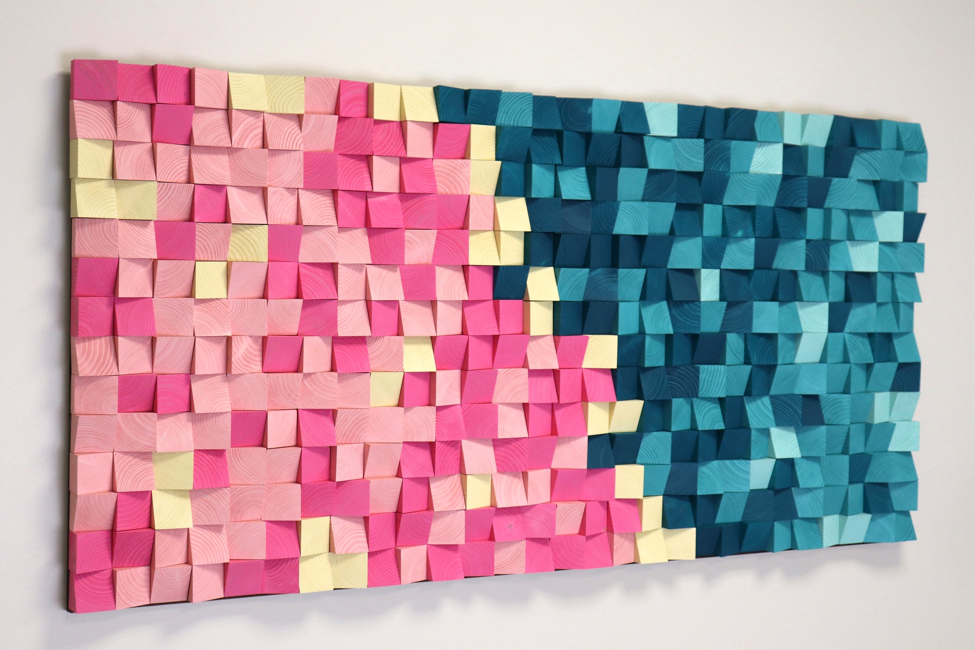 Geometric 3D wood wall panel with acoustic sound-diffusing design in blue and pink hues by WoodenPix.