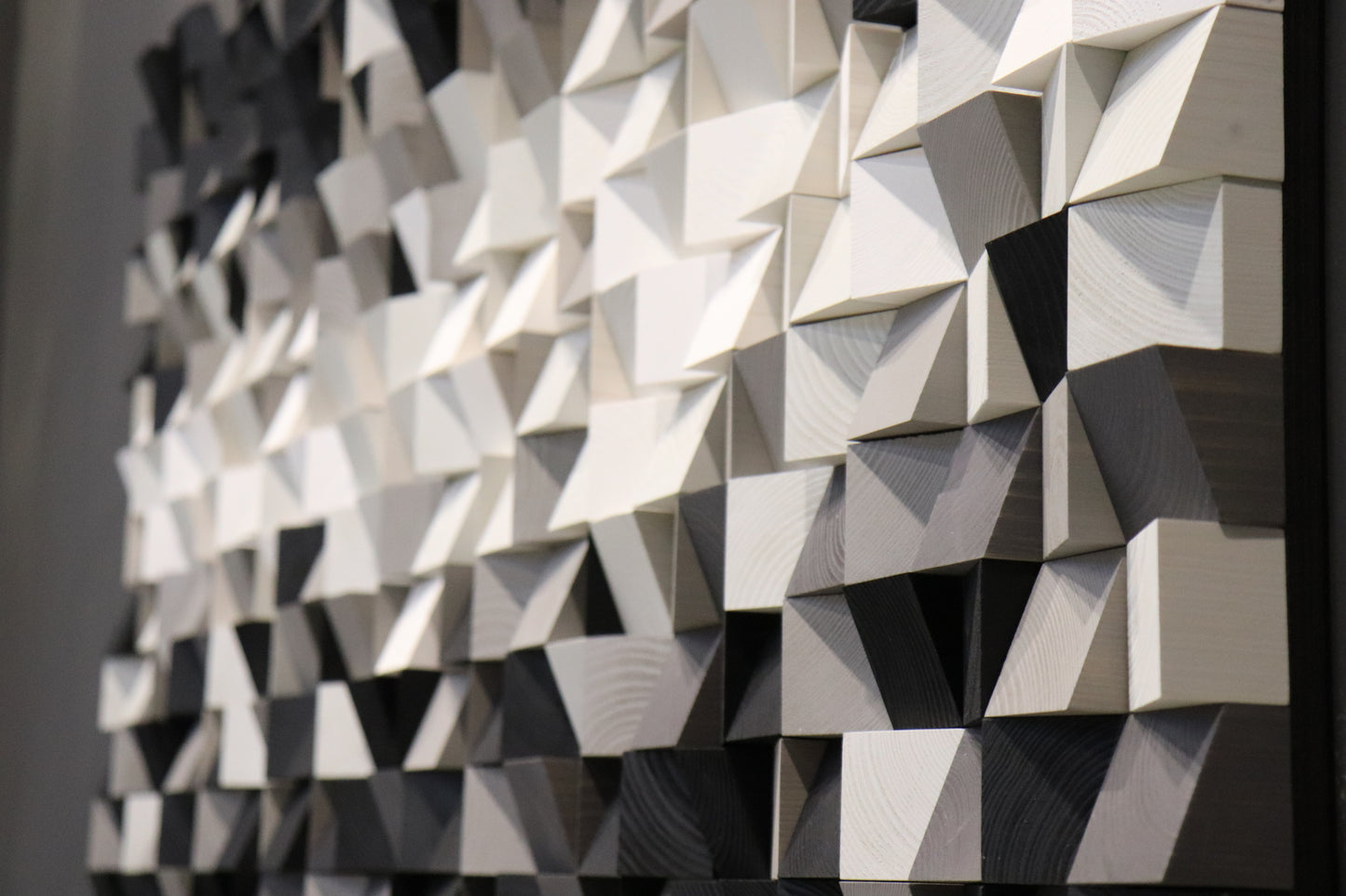 Abstract 3D wood wall art sculpture with sharp geometric lines and a smooth monochrome palette.