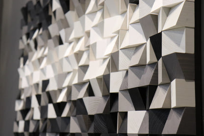 Abstract 3D wood wall art sculpture with sharp geometric lines and a smooth monochrome palette.