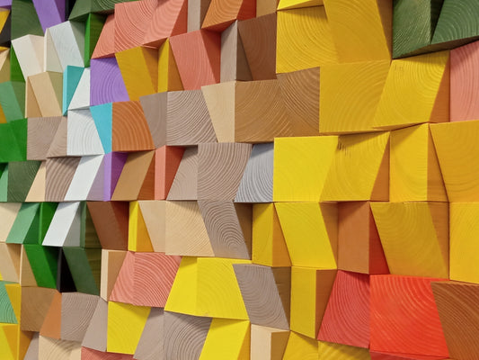 Handcrafted wooden wall art in autumn tones functioning as a decorative acoustic sound diffuser panel.