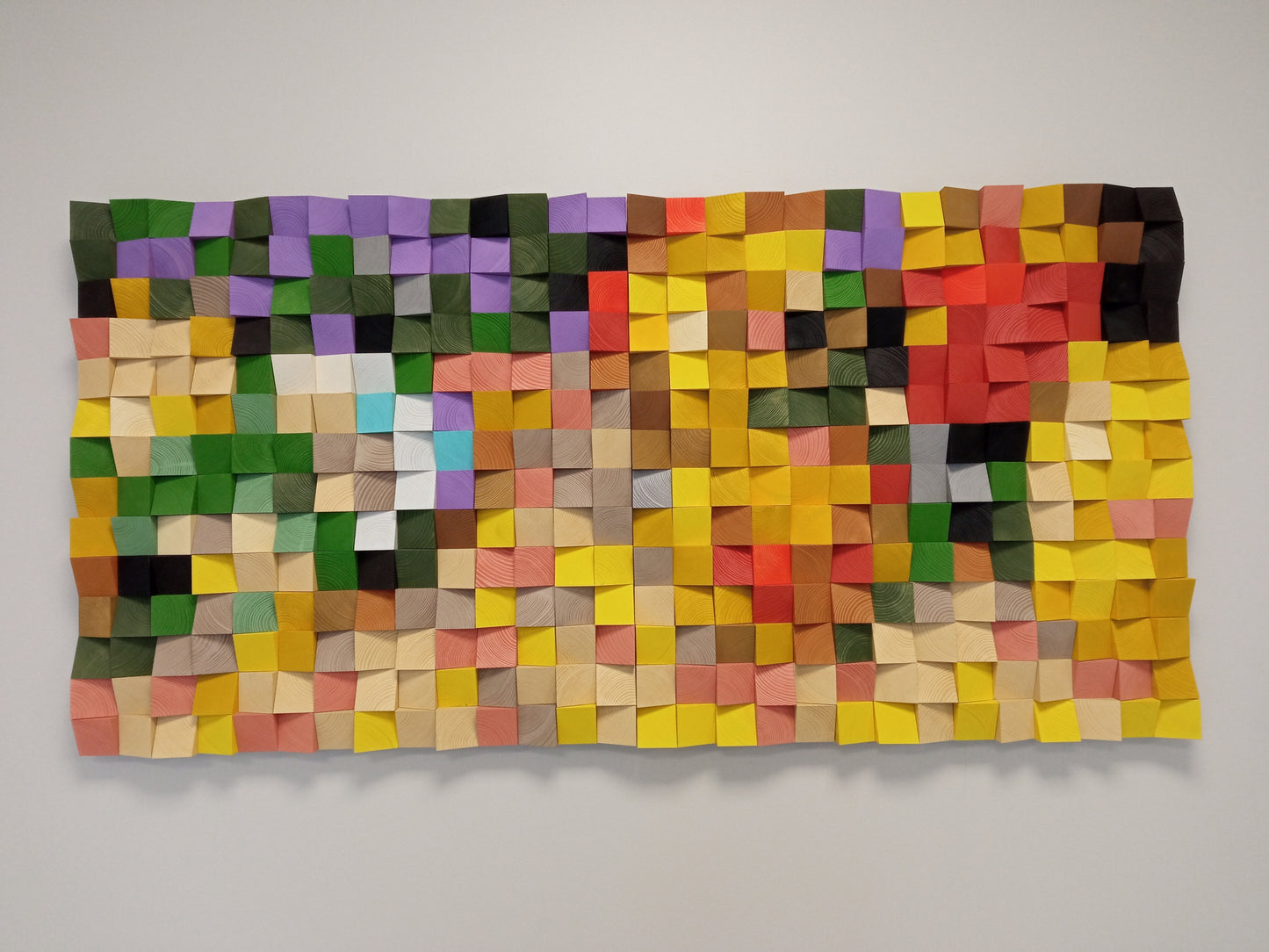 Modern wooden wall art with red, orange, and yellow tones that improves sound diffusion and room ambiance.