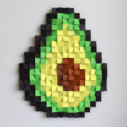 Handcrafted avocado artwork hanging on a wall, built from raised wood squares in green gradients.