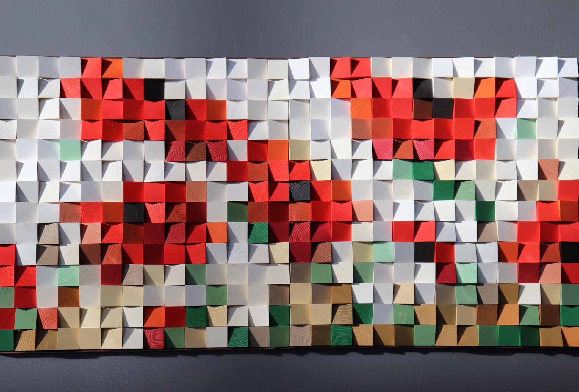 Handcrafted wooden wall panel artwork made from natural wood blocks with artistic texture.