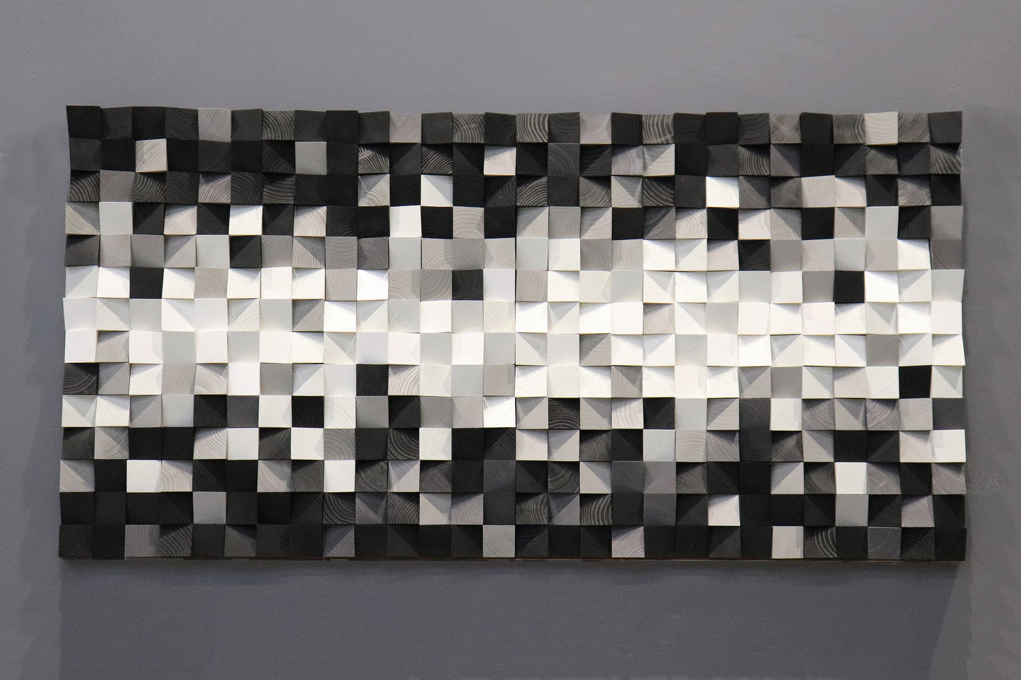 Minimalist wooden wall decoration showcasing elegant black and white contrasts with natural wood texture.