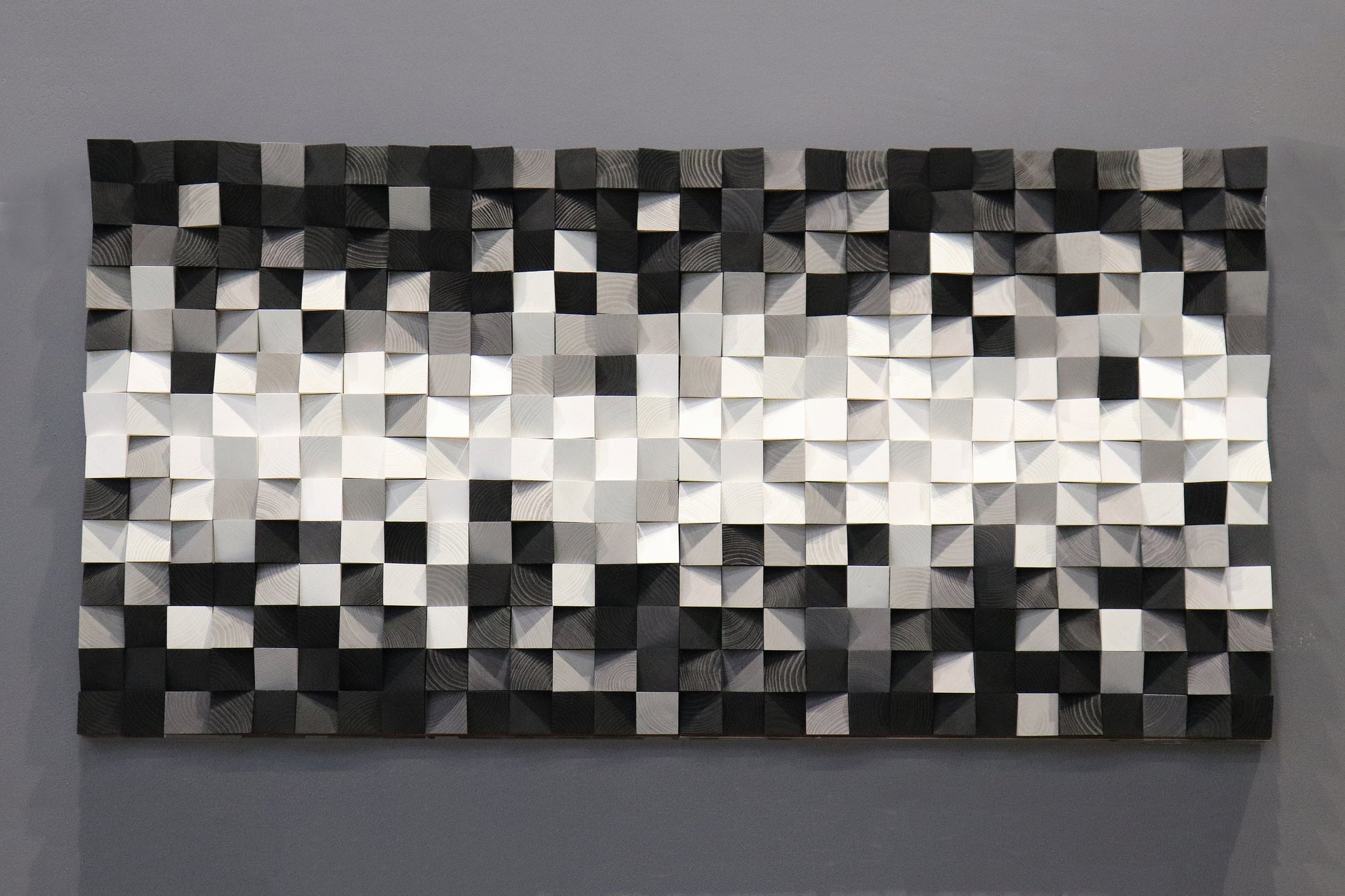 Minimalist wooden wall decoration showcasing elegant black and white contrasts with natural wood texture.