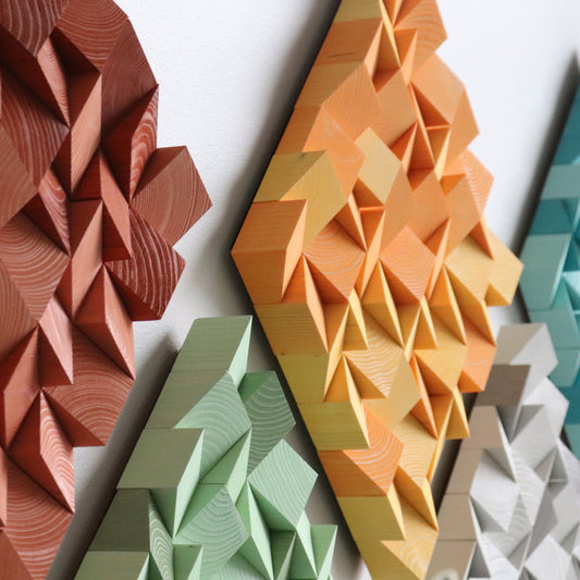 Colorful WoodenPix wall decor with mint, grey, orange, and terracotta square panels.