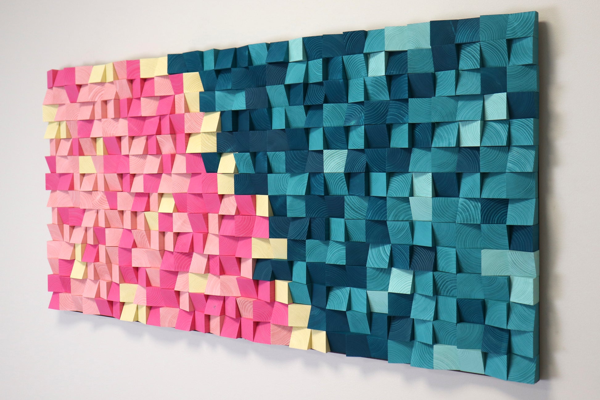 Pink and blue handcrafted wooden wall art that doubles as an acoustic sound diffuser for stylish home or studio interiors.