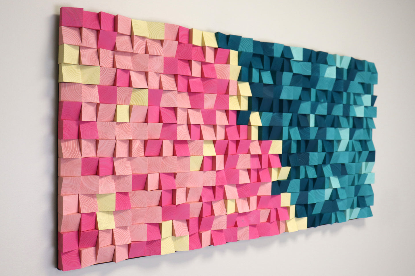 Decorative wooden sound panel with 3D geometric texture, combining pink, blue, and pastel tones.