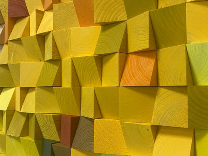 Handcrafted colorful wooden sound diffuser panel with warm autumn-inspired blocks and organic patterns.